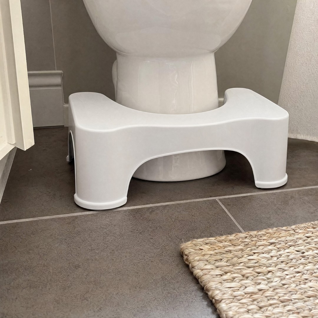 Squatty Potty tucked flush around the toilet base