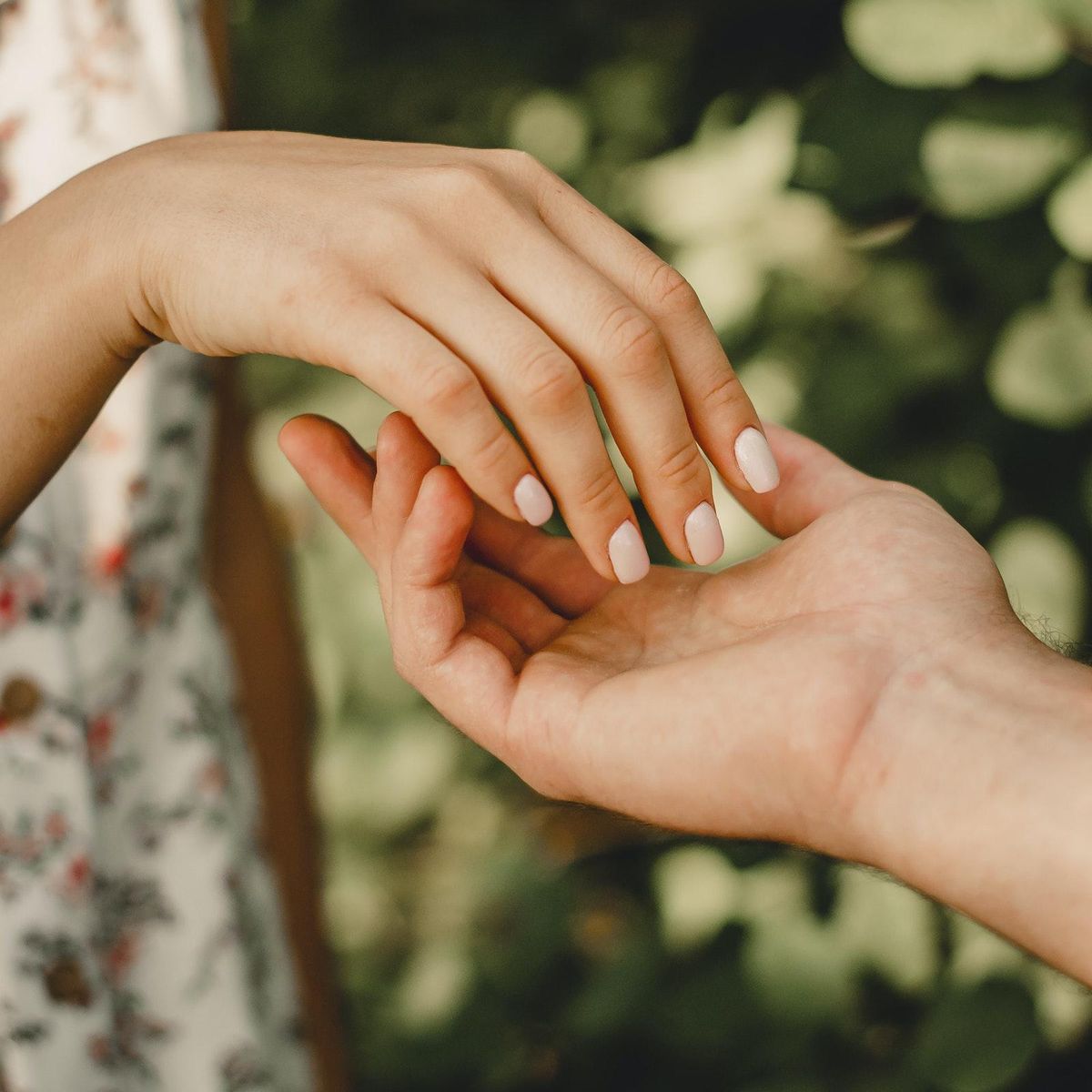 6 Types Of Intimacy holding hands outside in a garden