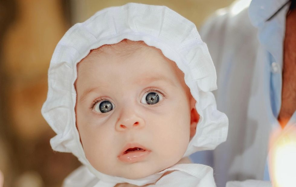 a baby girl with a bonnet on