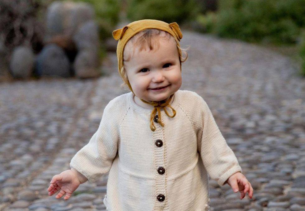a baby girl with a bonnet on