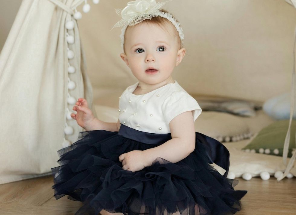 a baby wearing a bow and a tutu