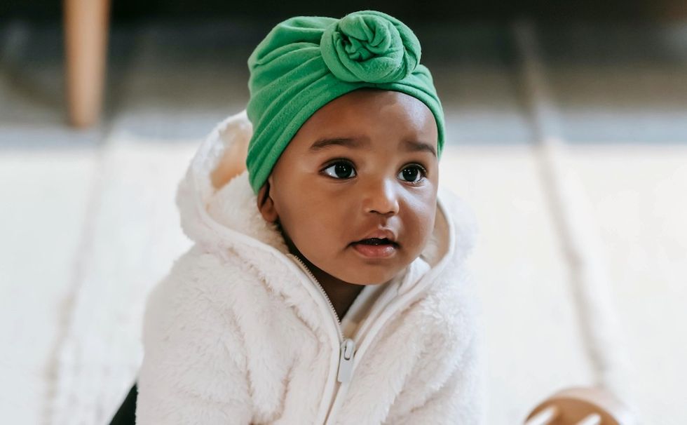 a baby with a green headband