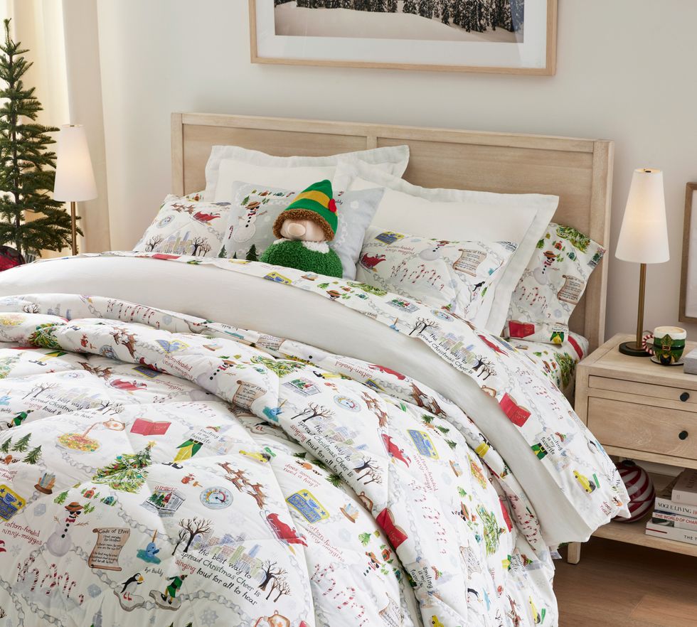 A bed is made with the PB x Elf comforter and sheet set.