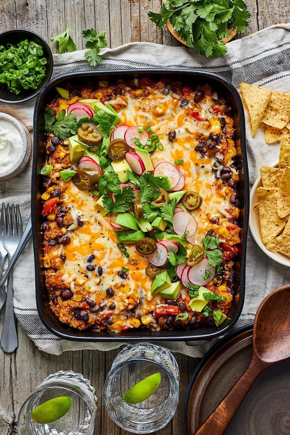 A black bean quinoa enchilada bake sits on top of a cloth.