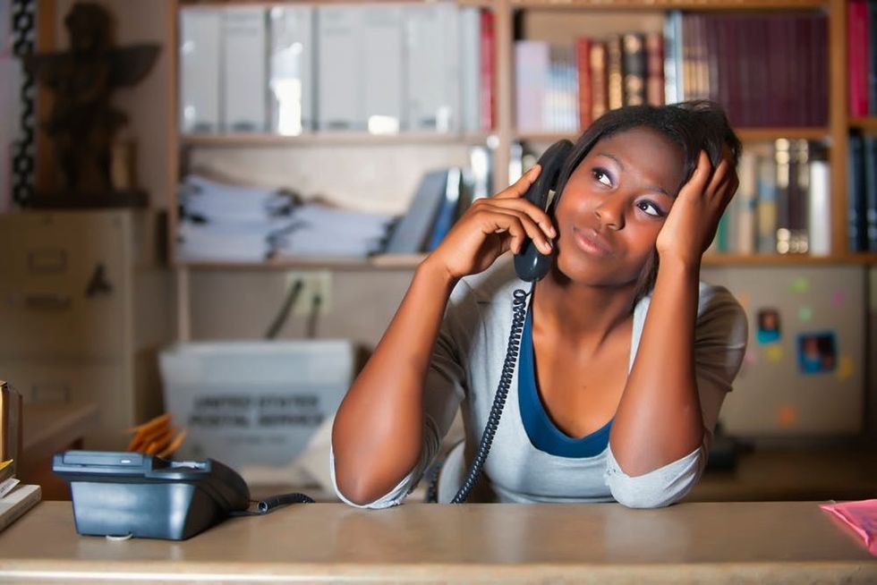 A bored woman sits on a phone call
