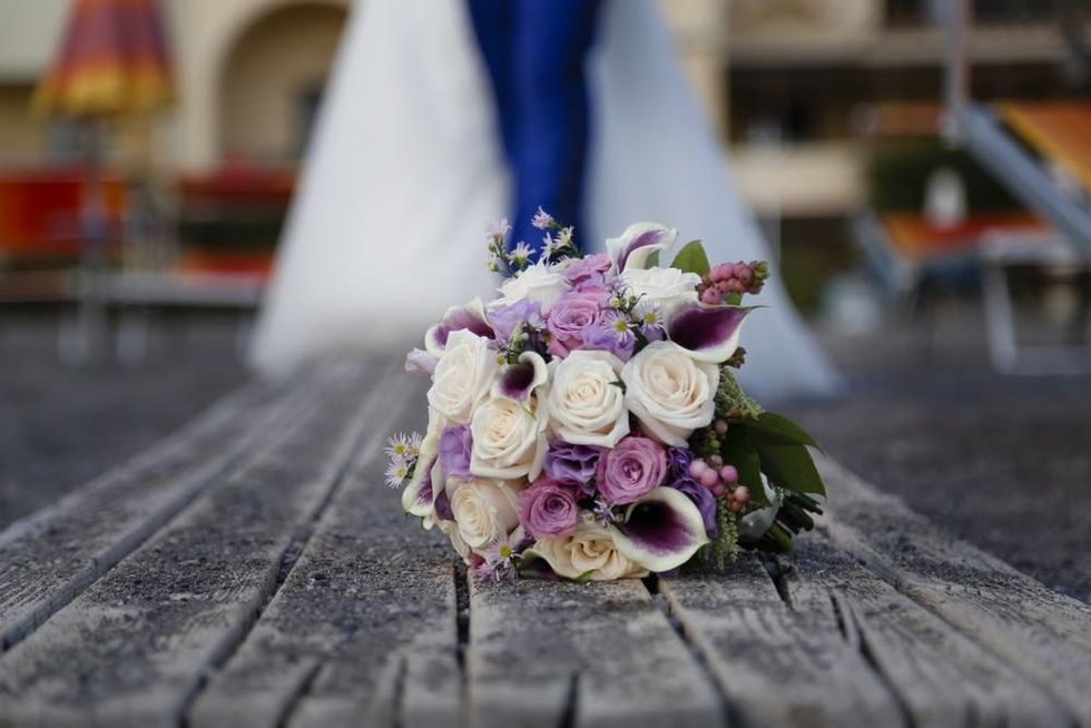 A bouquet of flowers rests on weathered wood