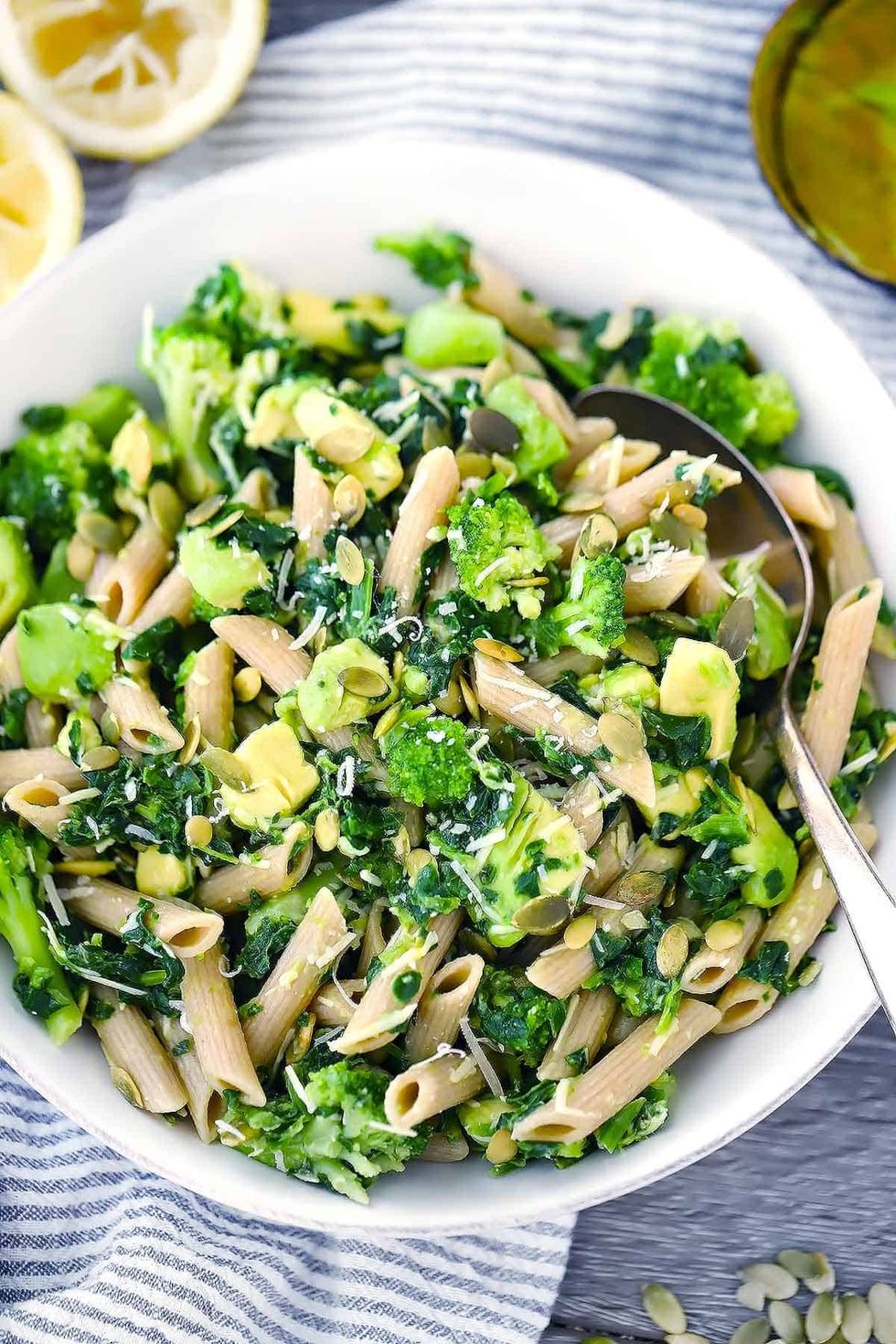 A bowl of Green Goddess pasta salad sits on top of a cloth.