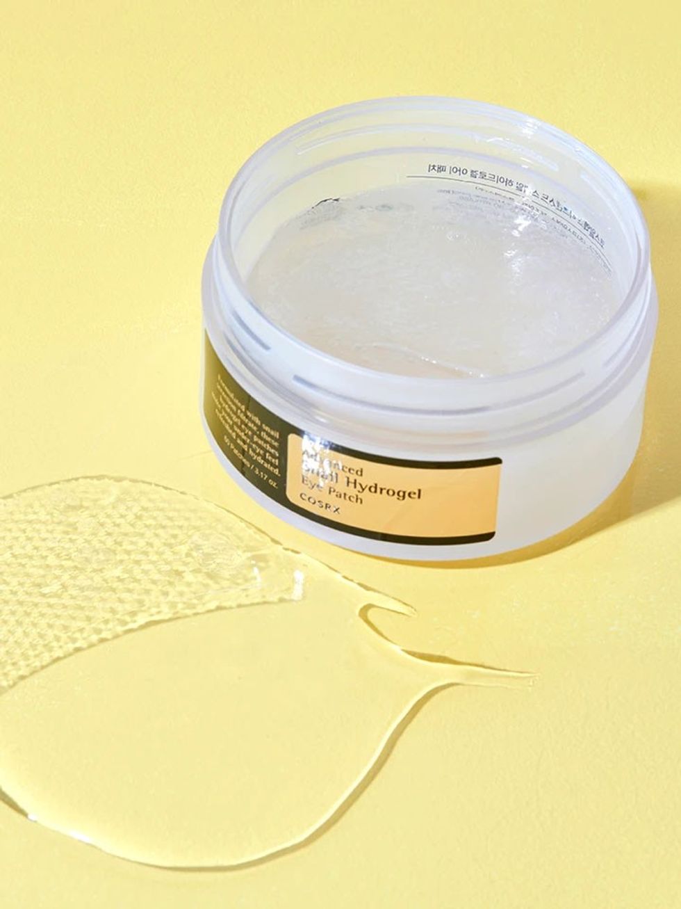 A container of Corsx eye patches are on a yellow background.