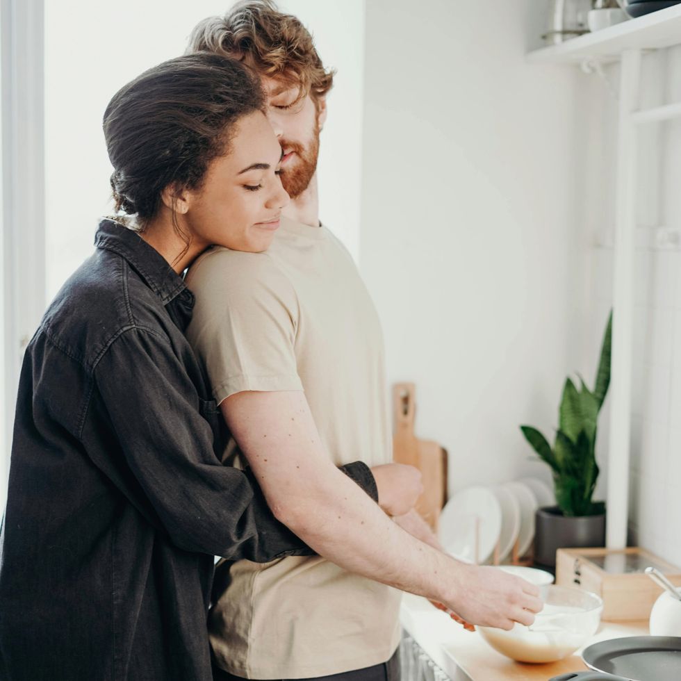 a couple cooking together in the kitchen