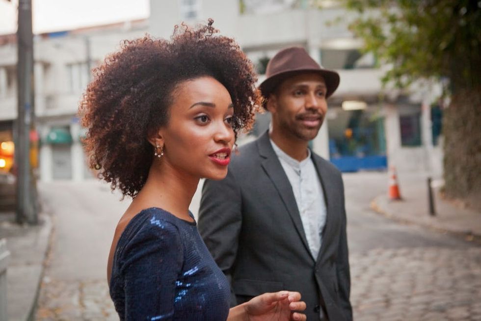A couple pauses in the street