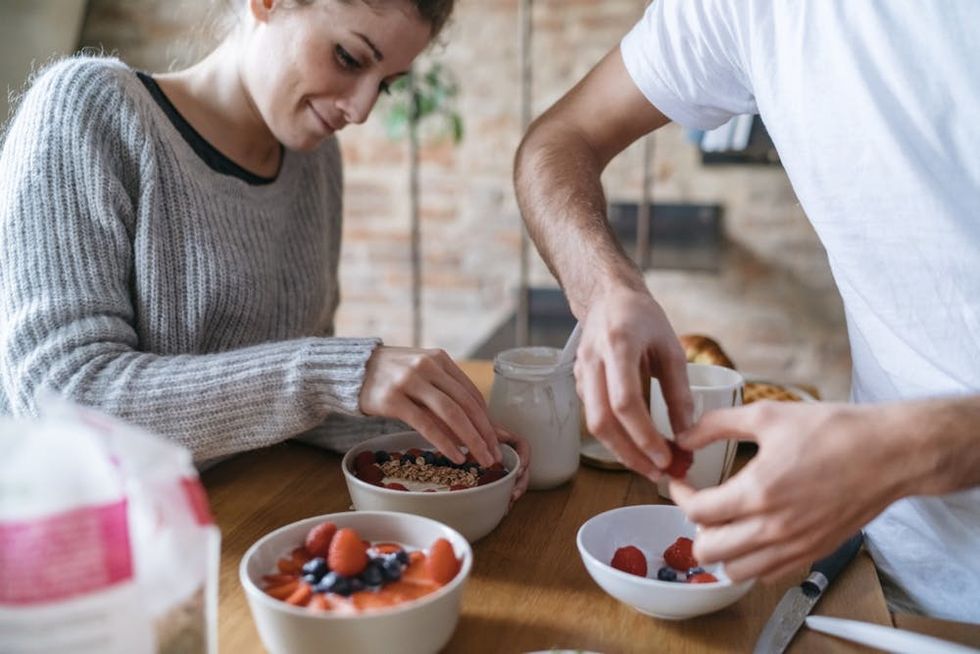 A couple prepares breakfast together