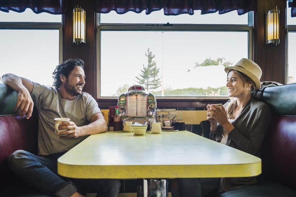 A couple sits across the table at a diner