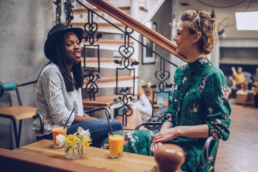 A couple sits talking in a coffeeshop