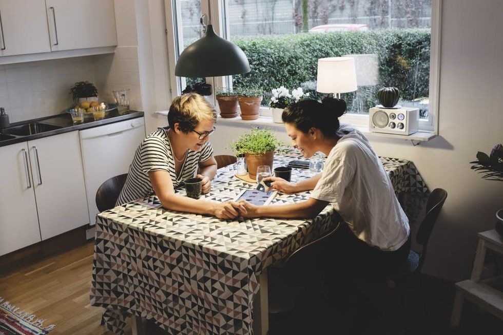 A couple sits together at their dining room table