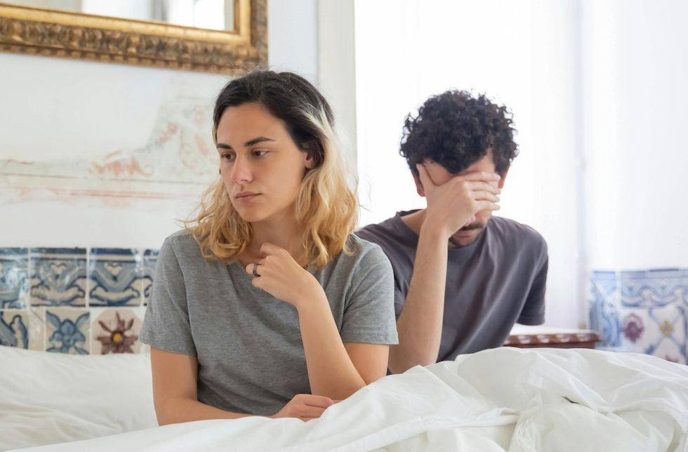 a couple sitting in bed next to each other
