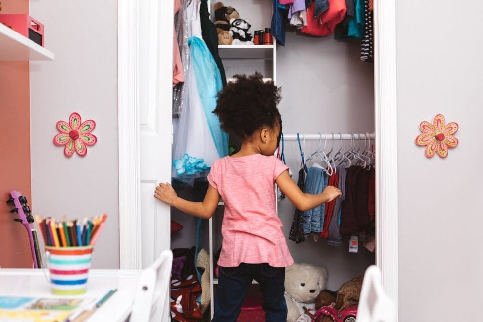 A girl looks in her closet