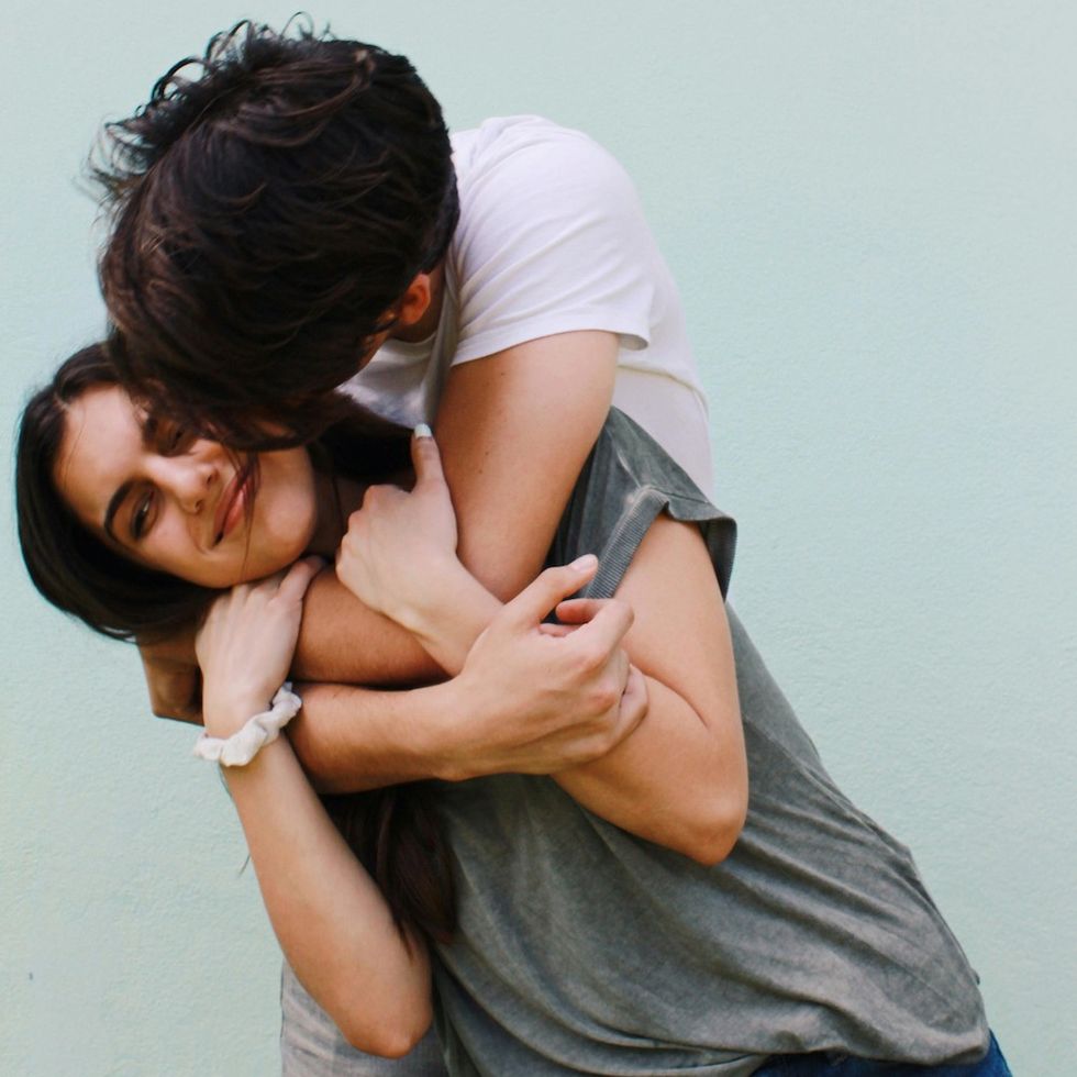 a man kissing a girl on the cheek