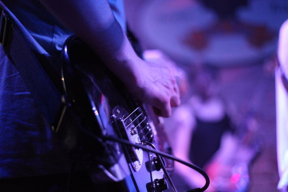 A man plays a guitar at an Austin venue