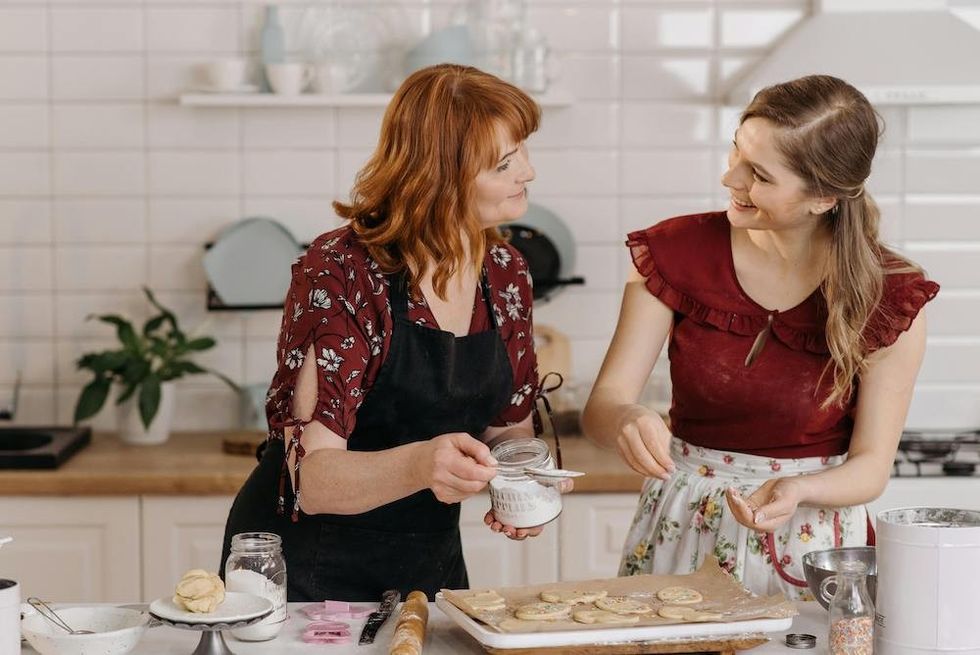 a mother and a daughter cooking together
