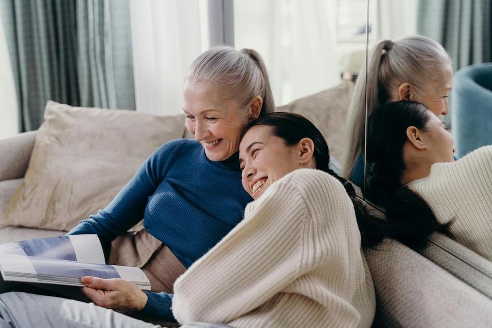 a mother and a daughter reading a book together