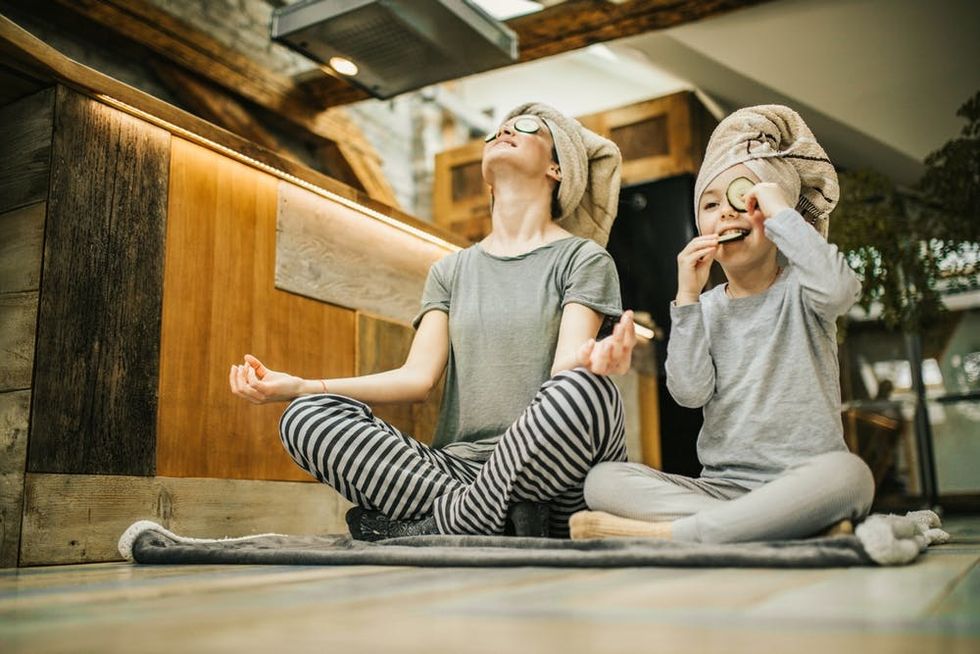A mother and child meditate together