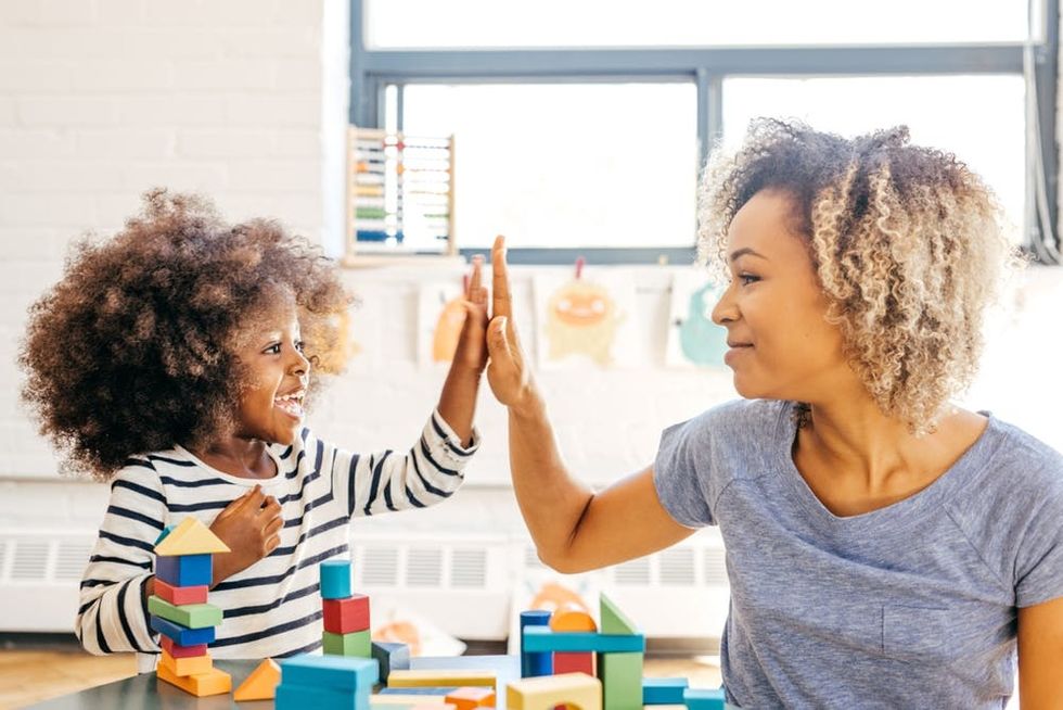 A mother and daughter high-five