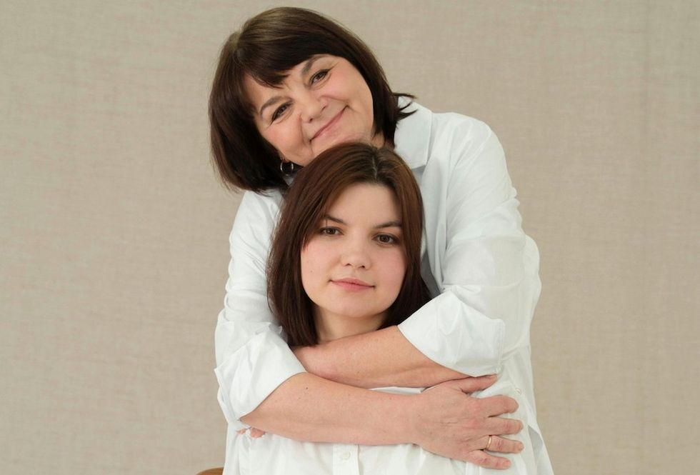 a mother hugging her daughter