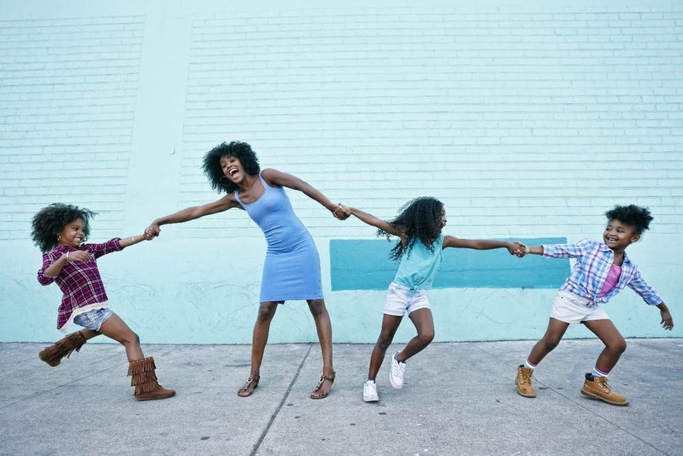 A mother plays with her children