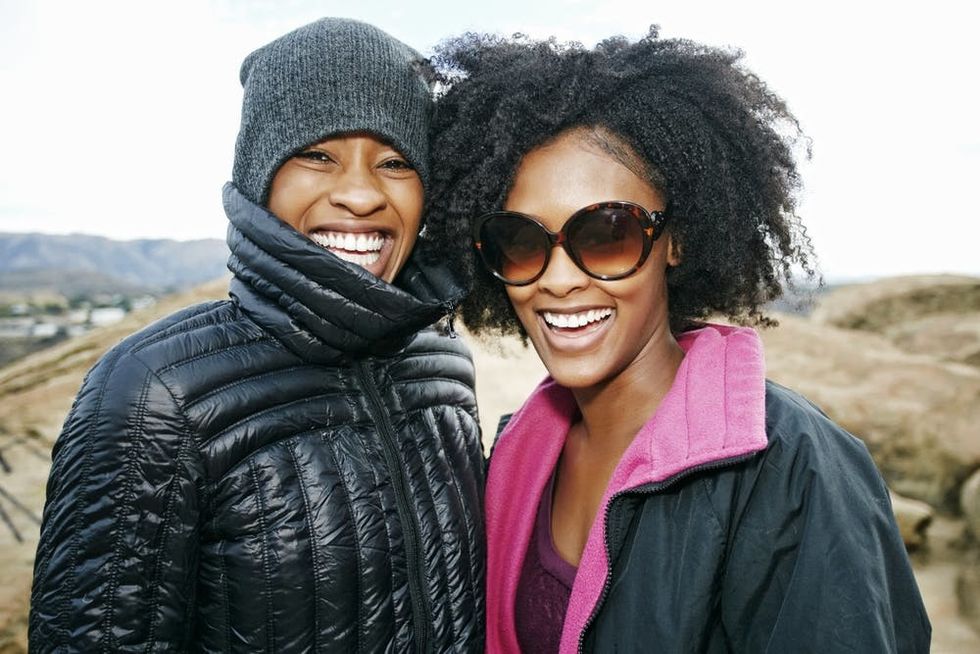 A pair of sisters smile together