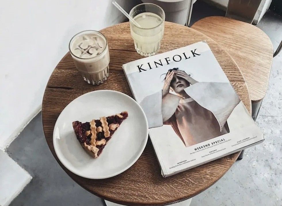 a piece of pie and a coffee next to a magazine