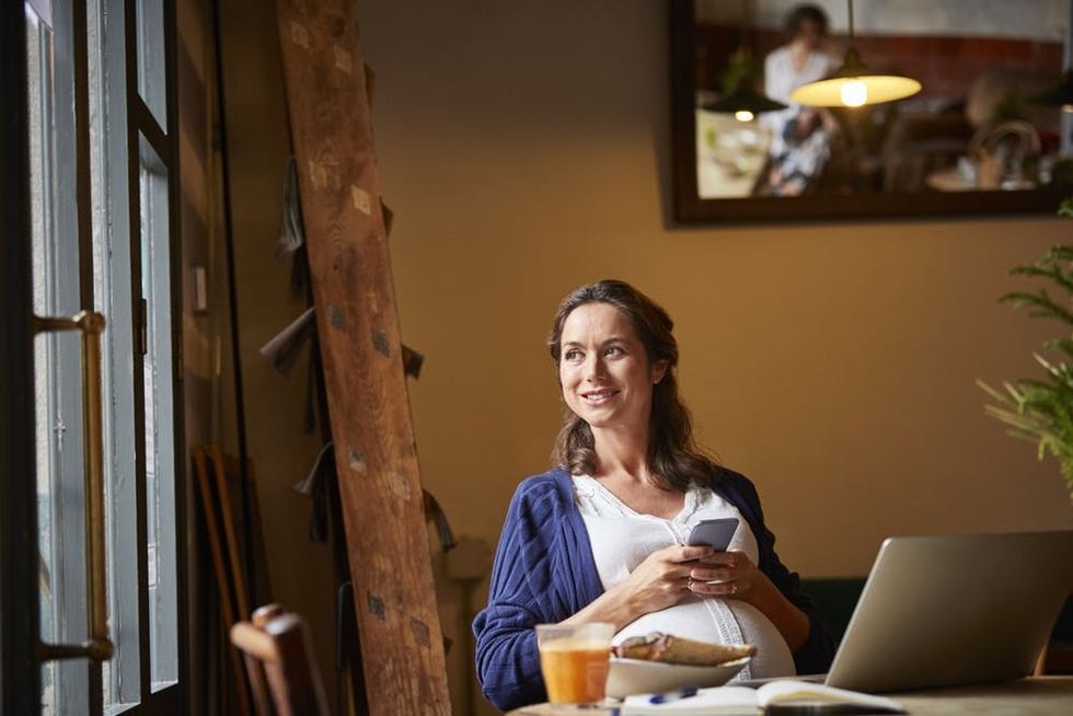 A pregnant woman dines at a restaurant
