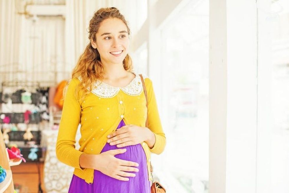 A pregnant woman shops in a store