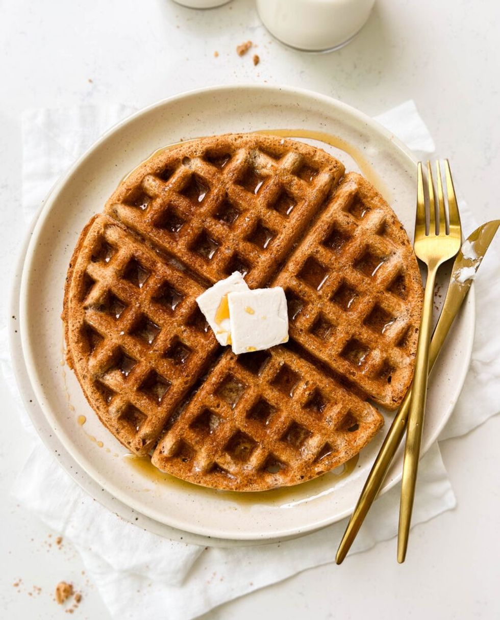 A vegan waffle has butter on top.