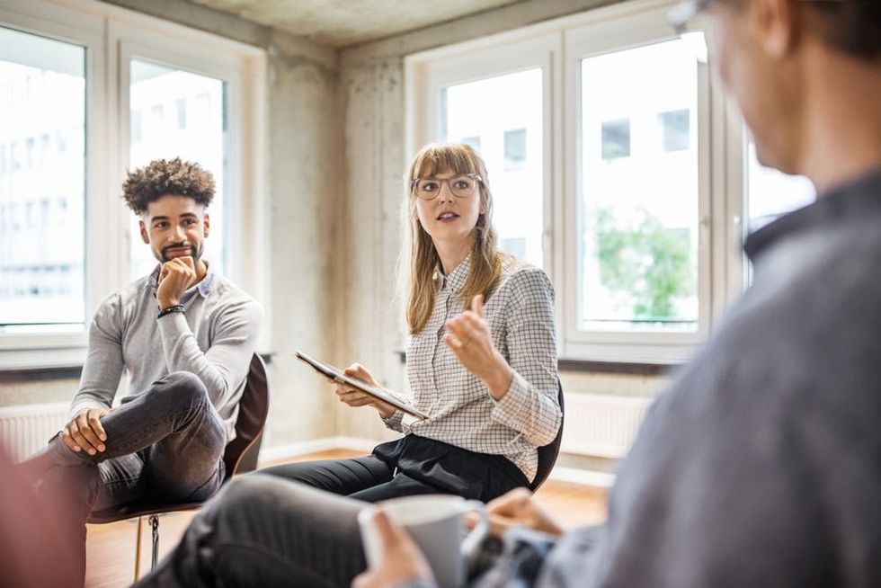 A woman asks a question at a meeting