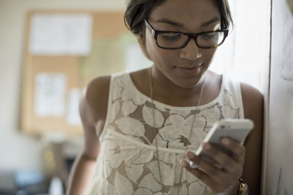 A woman checks her phone
