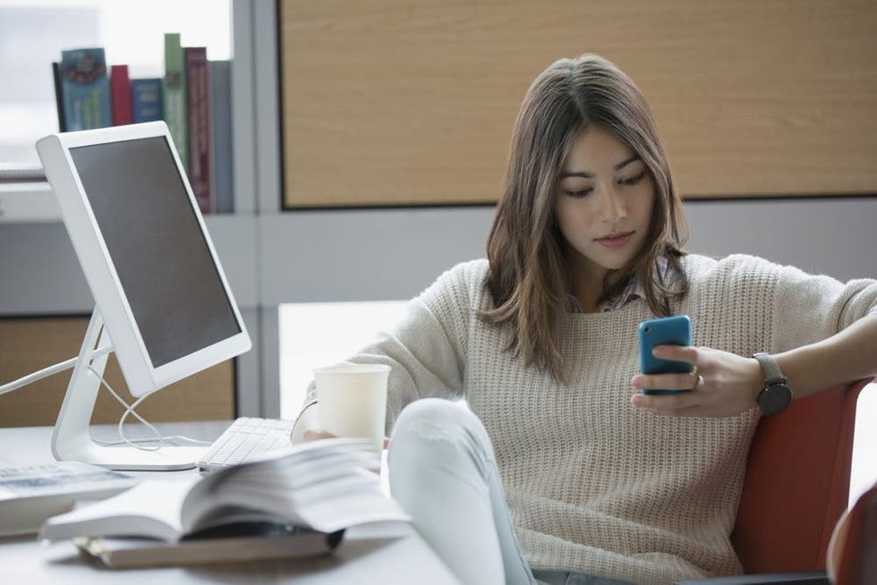 A woman checks her smartphone