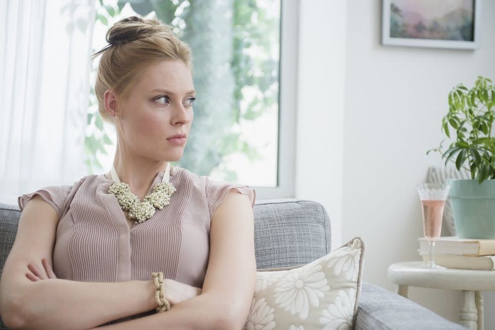 A woman crosses her arms angrily