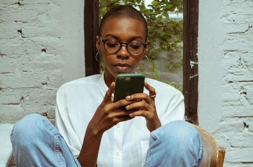 a woman dialing on her cell phone