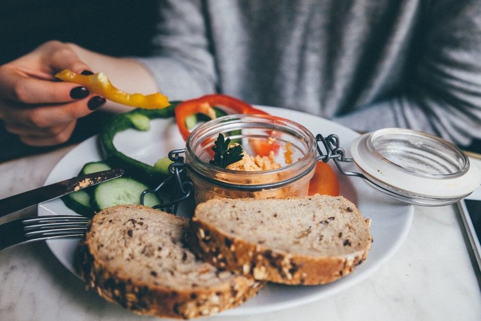 A woman eats a healthy lunch