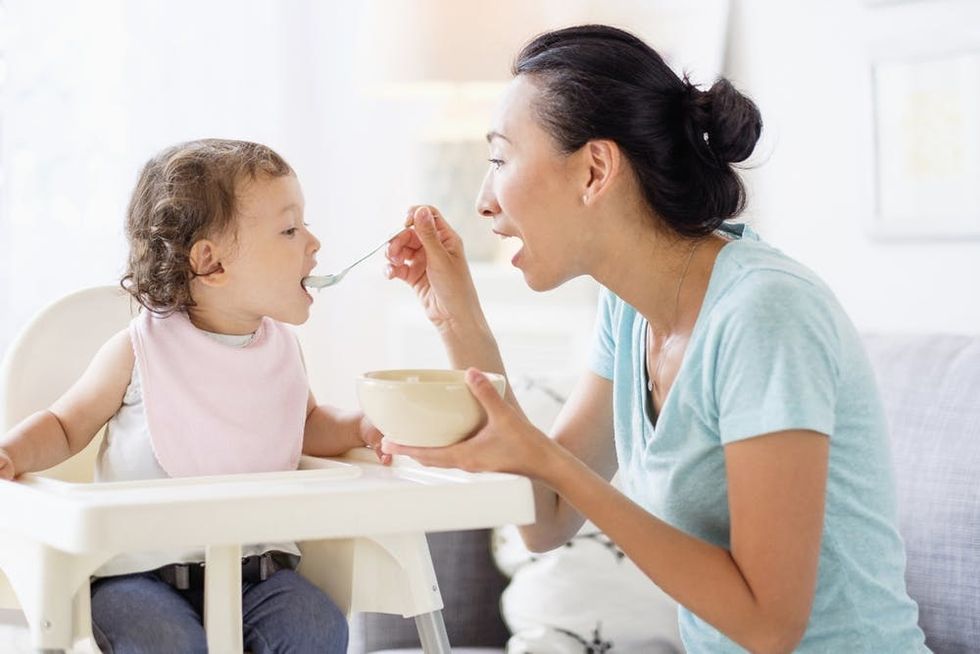 A woman feeds her baby