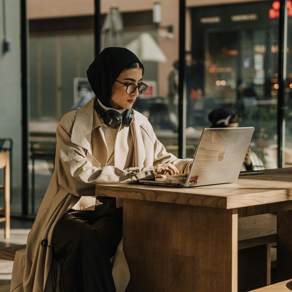 a woman focused on her laptop at work