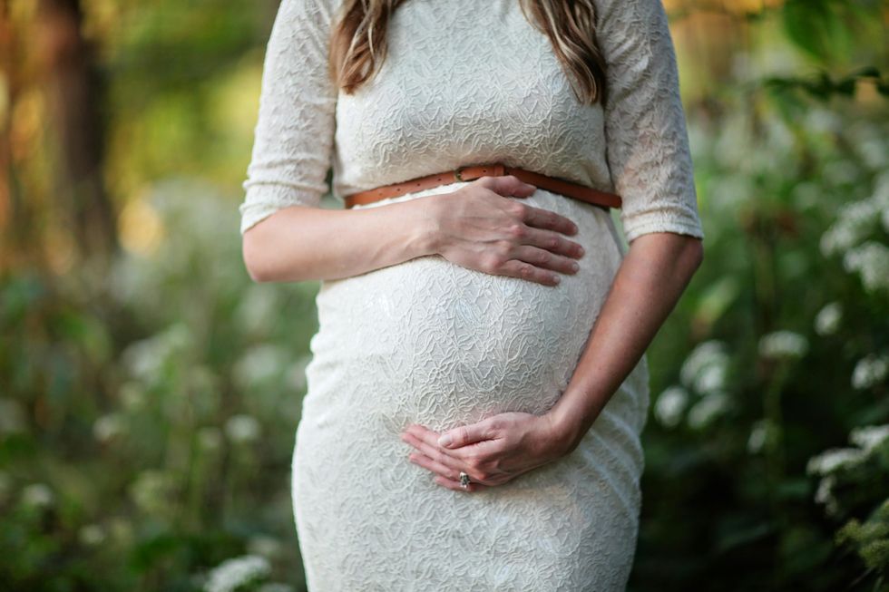 a woman holding her baby bump