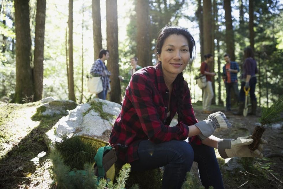 A woman holds a seedling