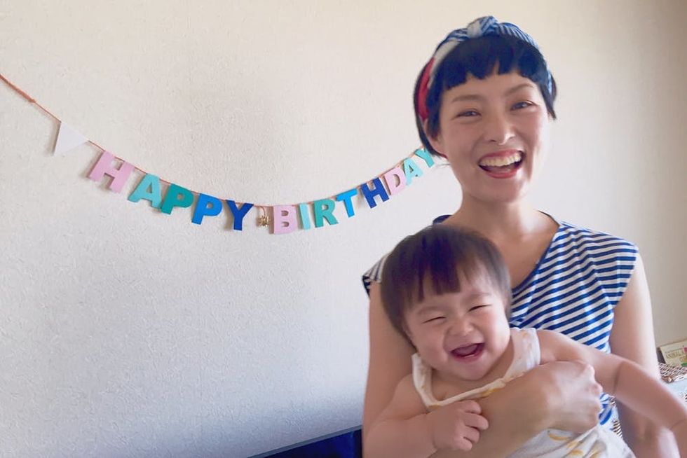 A woman laughs with her baby