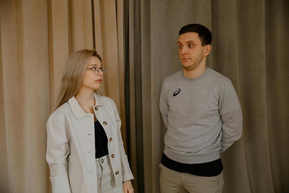 a woman looking at her underdressed boyfriend