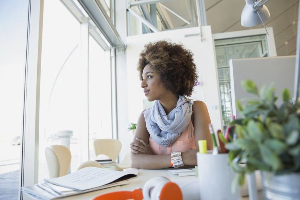 A woman looks out her office window