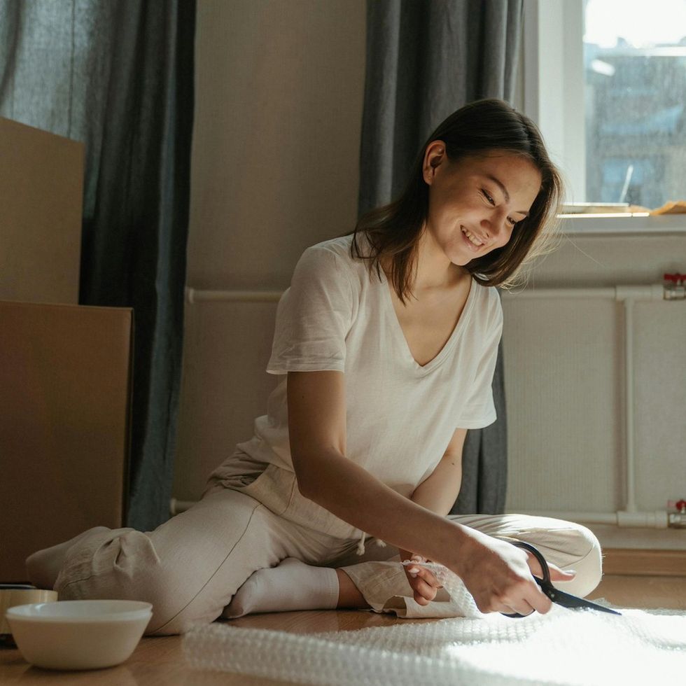a woman packing her things for a move