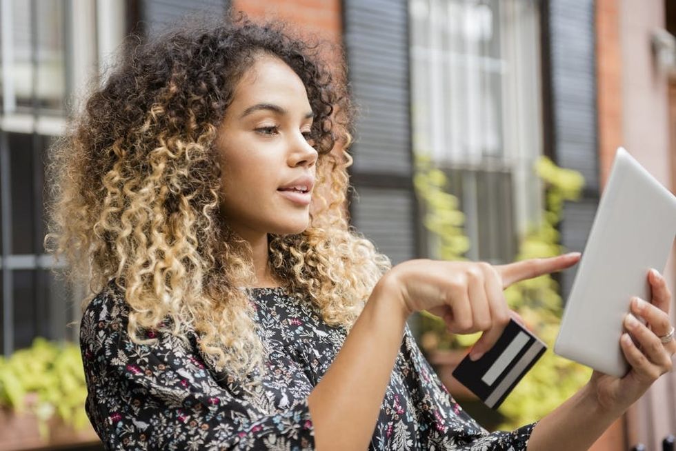 A woman pays a bill on her tablet