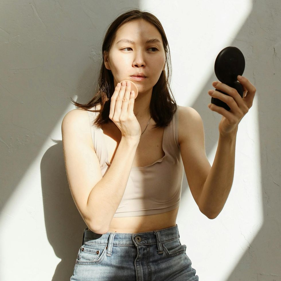 a woman putting on makeup