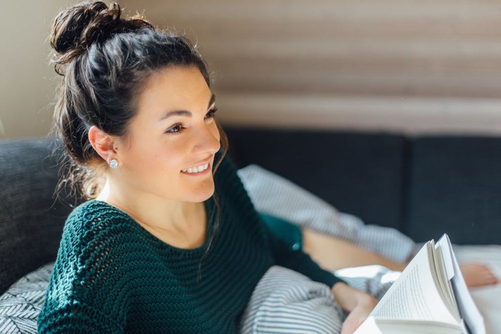 A woman reads in bed